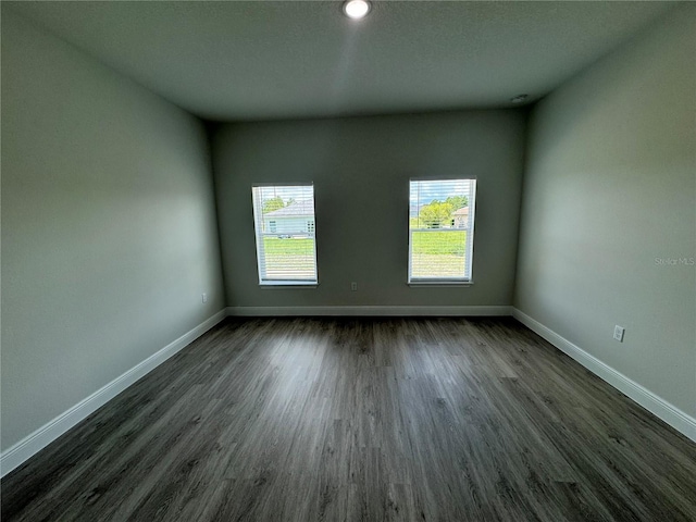 spare room with dark hardwood / wood-style floors