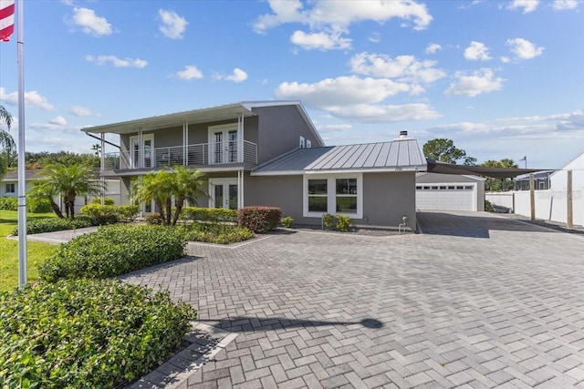 view of front facade featuring a balcony and a garage