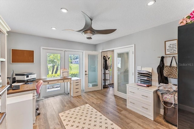 office space with french doors, a textured ceiling, light hardwood / wood-style flooring, and ceiling fan