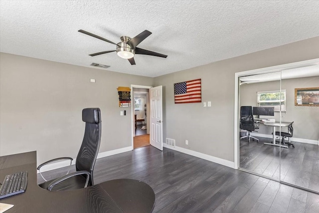 office space with ceiling fan, dark wood-type flooring, and a textured ceiling