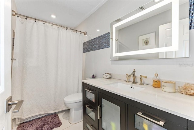 bathroom featuring tile patterned flooring, toilet, vanity, tile walls, and a shower with shower curtain