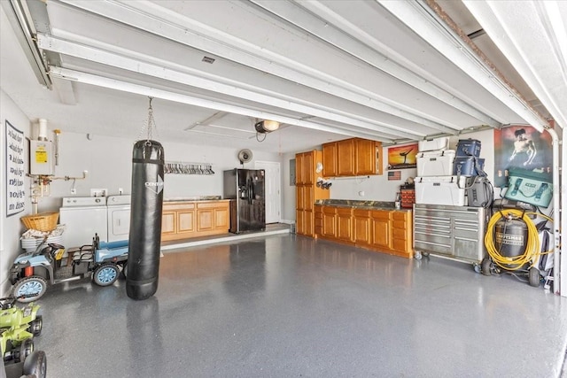 garage with independent washer and dryer, black fridge, and water heater