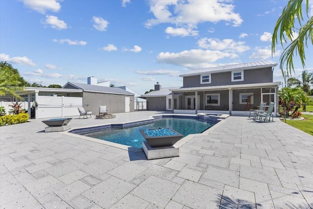 view of pool with a patio area and an in ground hot tub