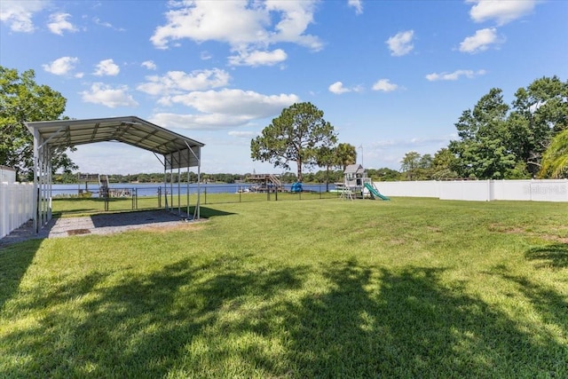 exterior space featuring a playground, a water view, and a carport