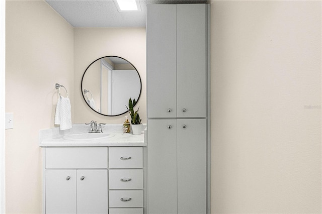 bathroom with a textured ceiling and vanity