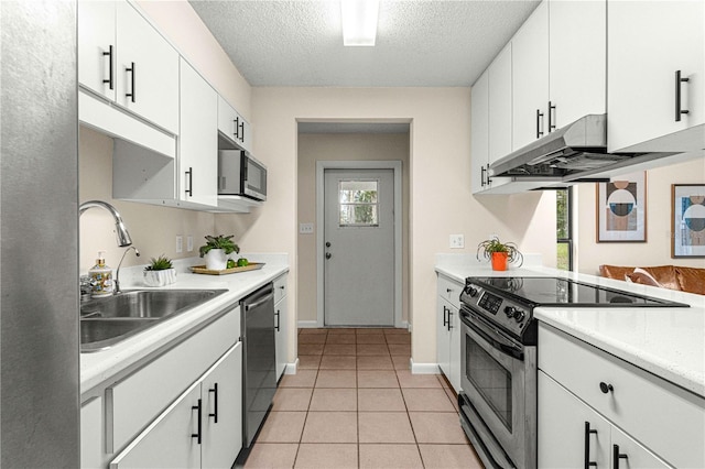 kitchen featuring sink, white cabinetry, stainless steel appliances, and a textured ceiling