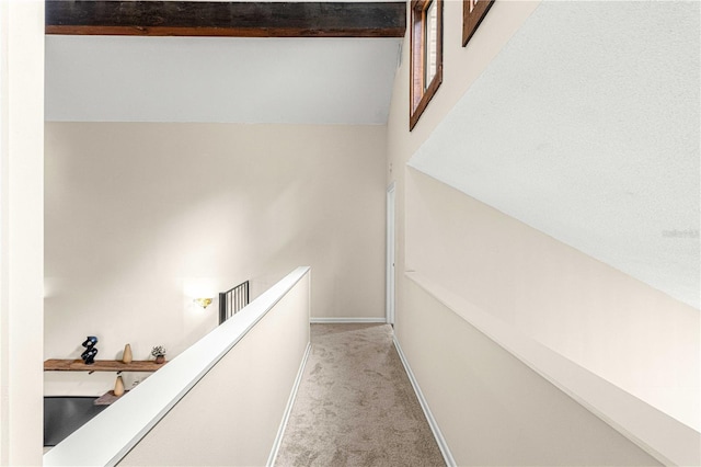 interior space featuring vaulted ceiling and light colored carpet