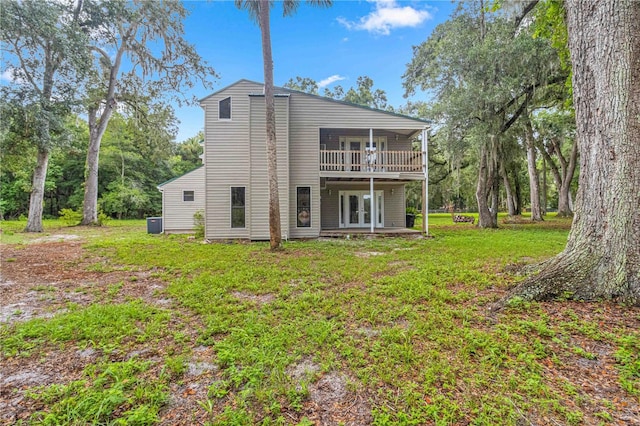 back of house with a wooden deck, french doors, and a yard