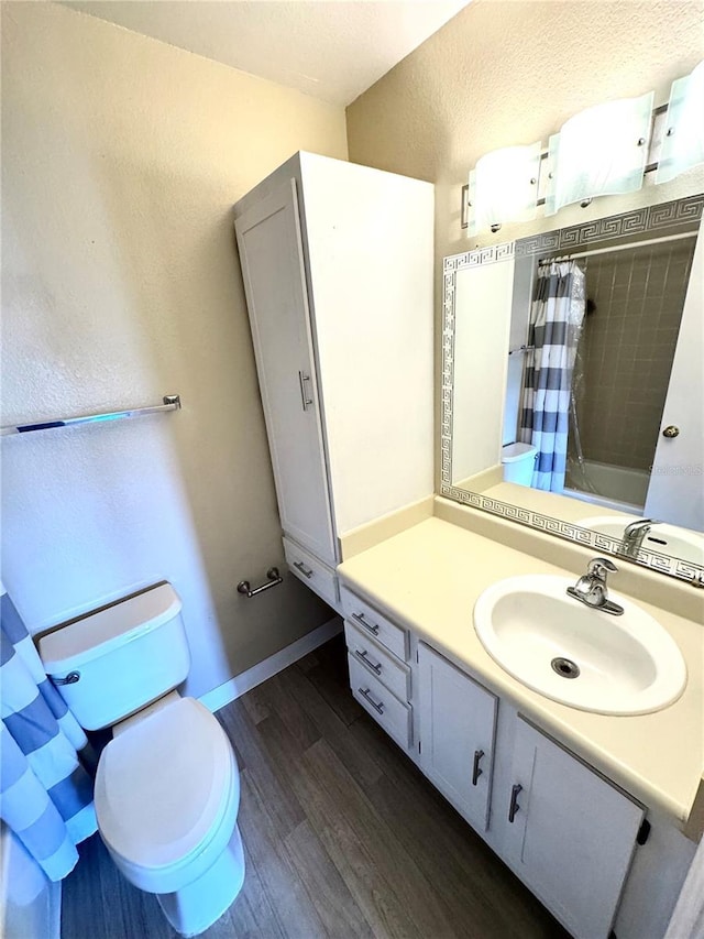 full bathroom with a shower with curtain, vanity, toilet, and wood finished floors