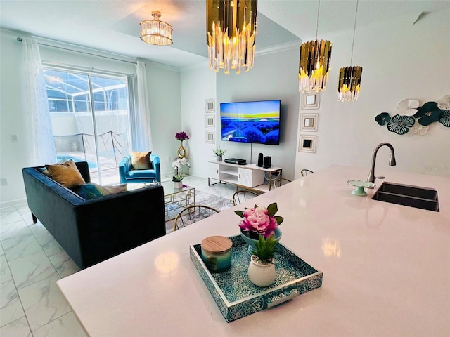 living room with a chandelier, crown molding, and sink