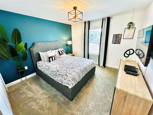 carpeted bedroom featuring a chandelier