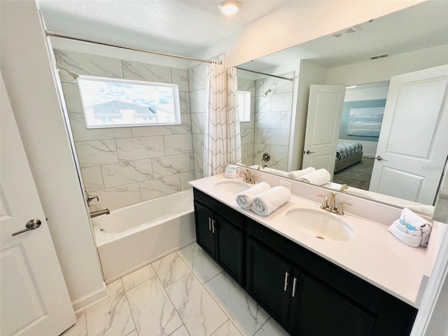 bathroom featuring shower / bath combo and vanity