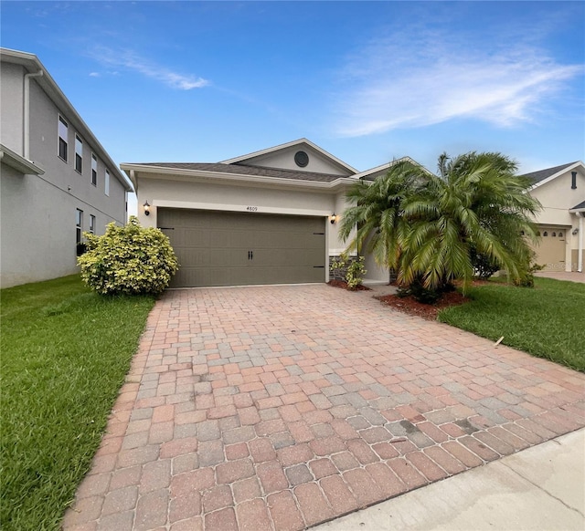 view of front of home featuring a garage and a front yard