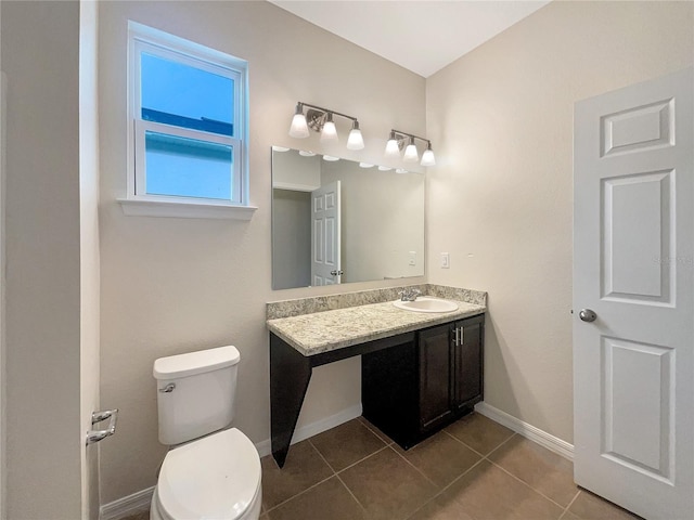 bathroom with tile patterned flooring, vanity, and toilet