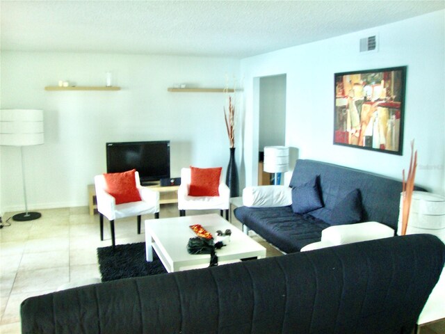 living room with light tile patterned floors and a textured ceiling