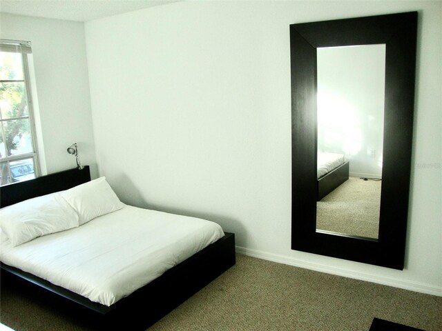 bedroom featuring light colored carpet