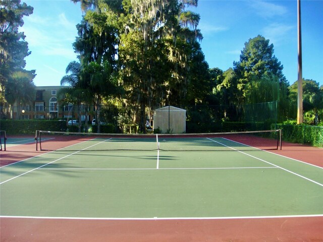 view of tennis court with basketball hoop