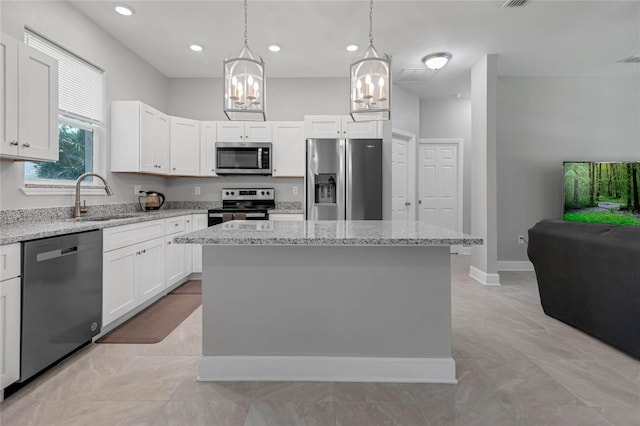 kitchen featuring white cabinetry, a center island, and stainless steel appliances