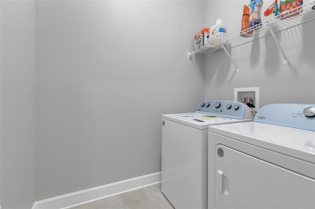 laundry room featuring independent washer and dryer and light tile patterned floors