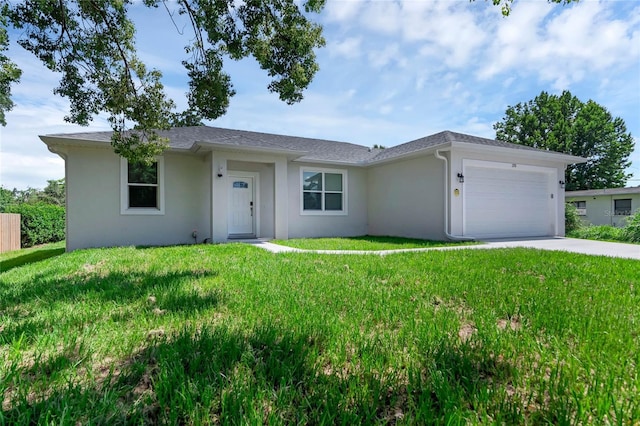 ranch-style home featuring a garage and a front lawn