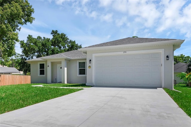 single story home with a garage and a front yard