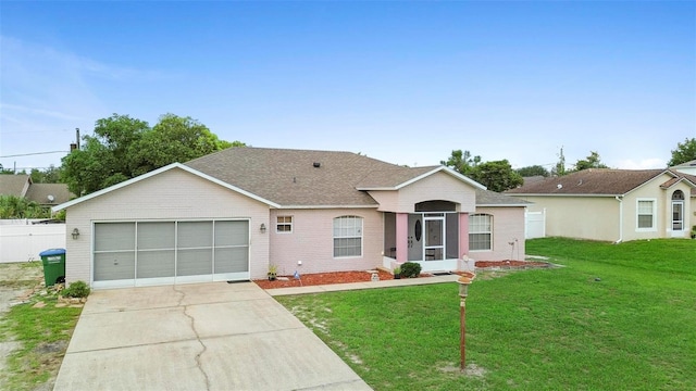 single story home featuring a garage and a front yard