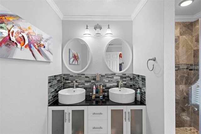 bathroom with a tile shower, vanity, ornamental molding, and tasteful backsplash