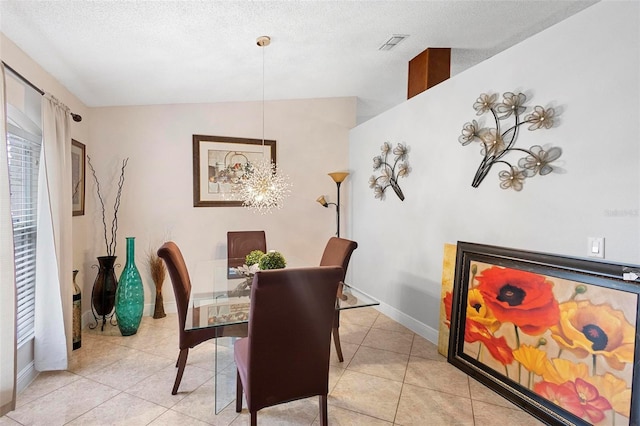 dining area with lofted ceiling, light tile patterned flooring, an inviting chandelier, and a textured ceiling