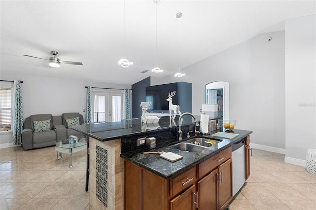 kitchen with sink, hanging light fixtures, a kitchen island with sink, vaulted ceiling, and stainless steel dishwasher