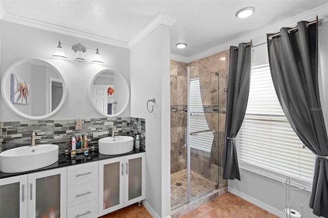 bathroom with ornamental molding, tile patterned flooring, tasteful backsplash, and a shower with door