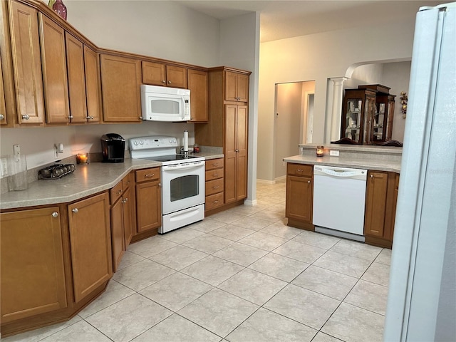 kitchen featuring white appliances and light tile patterned floors