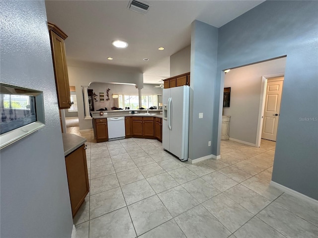 kitchen with white appliances, sink, and light tile patterned floors