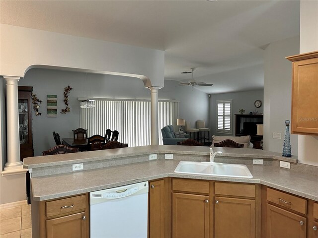 kitchen with white dishwasher, sink, ceiling fan, light tile patterned flooring, and kitchen peninsula