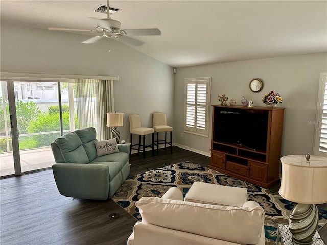 living room with plenty of natural light, ceiling fan, dark hardwood / wood-style flooring, and vaulted ceiling