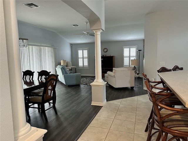 living room featuring ornate columns, ceiling fan, light tile patterned floors, and lofted ceiling