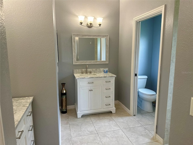 bathroom with tile patterned flooring, vanity, and toilet