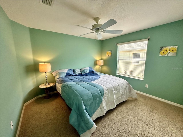 bedroom with carpet flooring, a textured ceiling, and ceiling fan