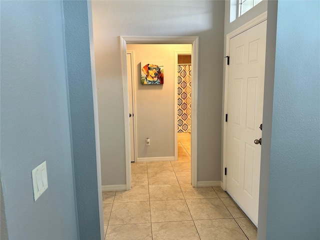 hallway with light tile patterned floors