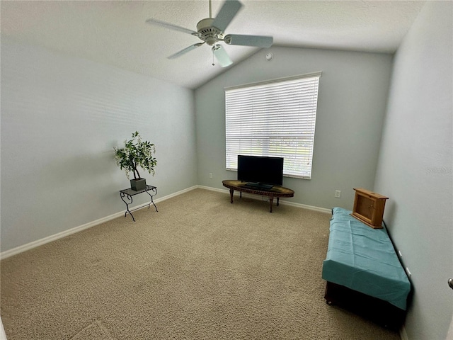 sitting room featuring ceiling fan, carpet floors, and vaulted ceiling