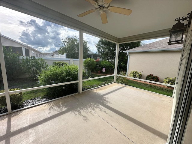 unfurnished sunroom featuring ceiling fan