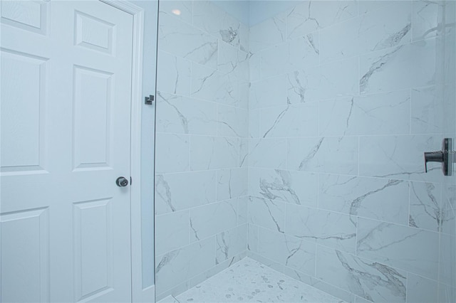 bathroom with a tile shower