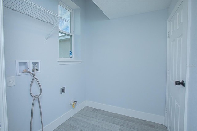 laundry area with electric dryer hookup, hookup for a washing machine, and light hardwood / wood-style flooring