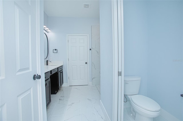 bathroom featuring toilet and vanity