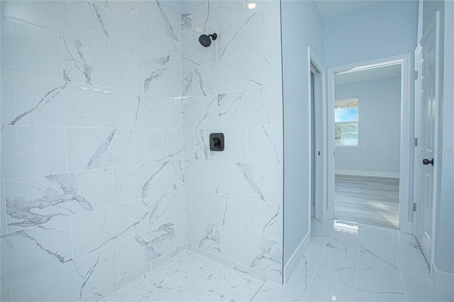 bathroom with a tile shower