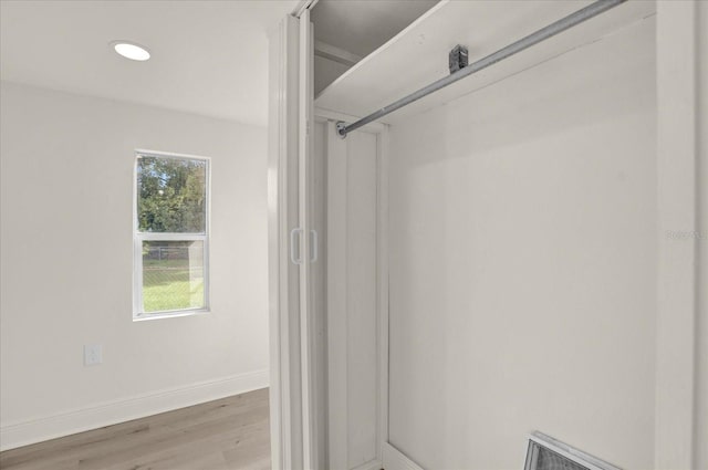 bathroom with hardwood / wood-style floors