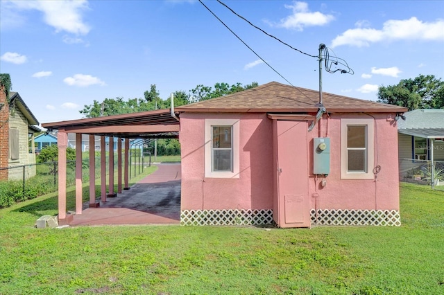 view of outdoor structure featuring a yard and a carport