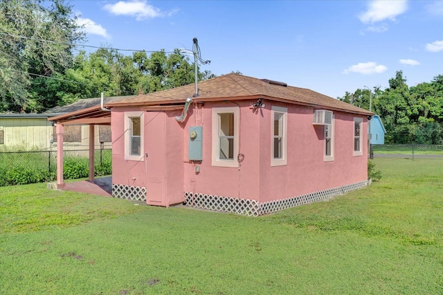 view of side of home with a yard