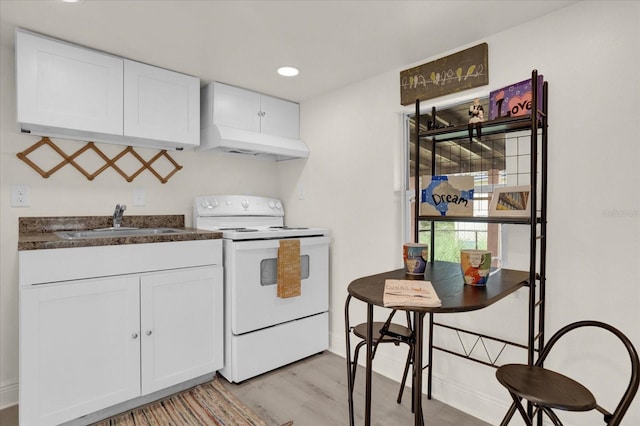 kitchen featuring white cabinets, sink, light hardwood / wood-style floors, and white electric range oven