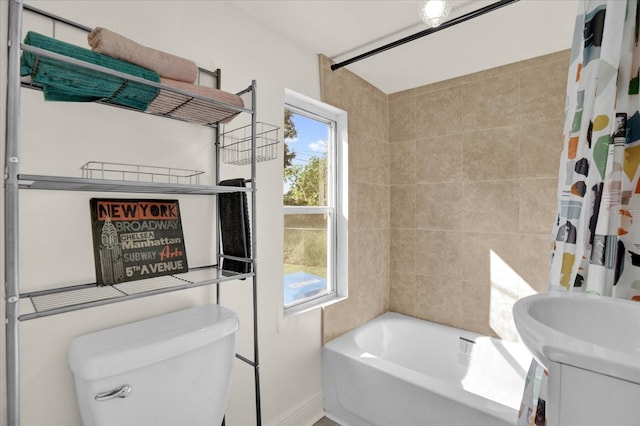 bathroom featuring toilet and shower / bath combination with curtain