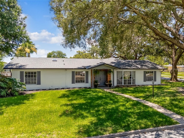 single story home featuring a front lawn